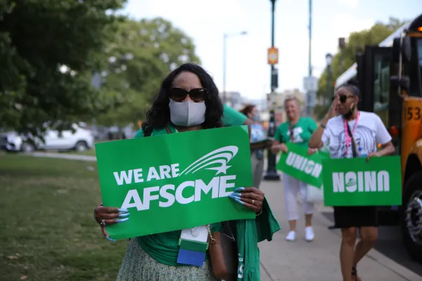 AFSCME member holding sign